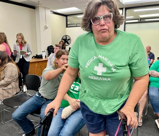 Lia Post, of Springfield, Neb., leaves a meeting of the Nebraska Medical Cannabis Commission, where she sobbed and begged its members to honor the will of the voters in approving comprehensive access to medical marijuana, Tuesday, Sept. 30, 2025 in Lincoln, Neb. (AP Photo/Margery Beck)