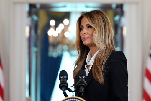 First lady Melania Trump turns from the podium after speaking in the Grand Foyer of the White House, Friday, Oct. 10, 2025, in Washington. (AP Photo/Alex Brandon)