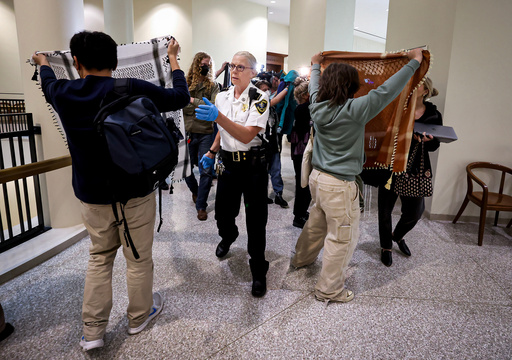 A court officer clears the area outside of a courtroom, Wednesday, Oct. 8, 2025, at Boston Municipal Court, where arraignments were held for protesters arrest at a pro-Palestinian rally in Boston on Tuesday night. (Mark Stockwell/The Boston Herald via AP, Pool)