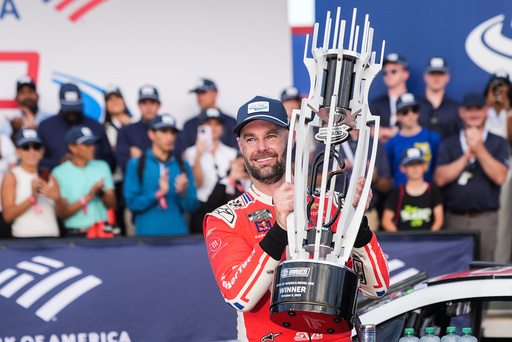 Shane van Gisbergen celebrates in Victory Lane after winning a NASCAR Cup Series auto race at Charlotte Motor Speedway, Sunday, Oct. 5, 2025, in Concord, N.C. (AP Photo/Matt Kelley)