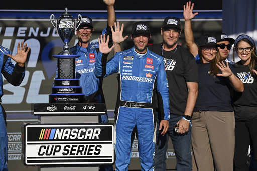 Denny Hamlin, center, celebrates after winning a NASCAR Cup Series auto race at World Wide Technology Raceway, Sunday, Sept. 7, 2025, in Madison, Ill. (AP Photo/Connor Hamilton)