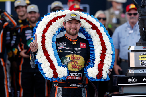 Driver Chase Briscoe celebrates with a victory wreath after winning a NASCAR Cup Series auto race at Talladega Superspeedway, Sunday, Oct. 19, 2025, in Talladega, Ala. (AP Photo/Butch Dill)