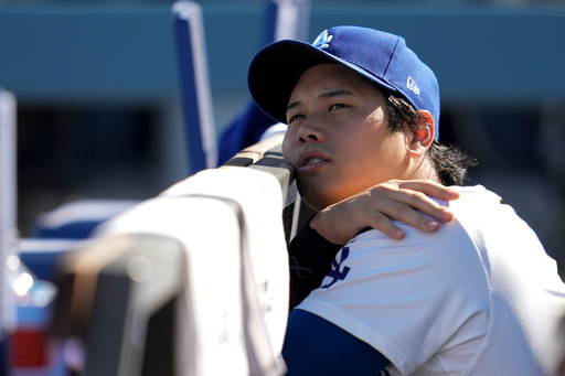 Los Angeles Dodgers' Shohei Ohtani wait for the start of Game 3 of baseball's National League Championship Series between the Milwaukee Brewers and the Los Angeles Dodgers, Thursday, Oct. 16, 2025, in Los Angeles. (AP Photo/Ashley Landis)