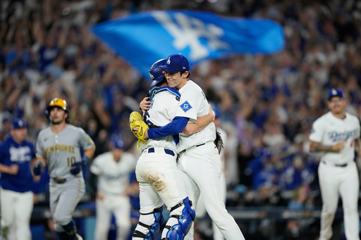 Los Angeles Dodgers pitcher Roki Sasaki and catcher Will Smith celebrates their win against the Milwaukee Brewers in Game 4 of baseball's National League Championship Series, Friday, Oct. 17, 2025, in Los Angeles. (AP Photo/Brynn Anderson)