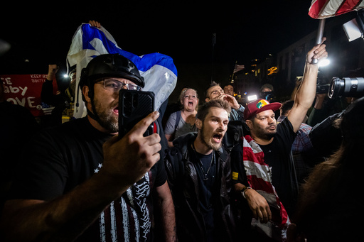 Trump supporters face off with protesters outside a U.S. Immigration and Customs Enforcement facility in Portland, Ore., Monday, Oct. 6, 2025. (AP Photo/Ethan Swope)