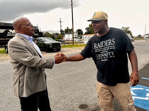 Orleans Parish Clerk of Court Candidate Calvin Duncan, left, shakes hands with Raymond Flanks Sept. 25, 2025 in New Orleans. Flanks was released from prison in 2022 after a judge vacated Flanks' conviction in a 1983 murder ending his nearly four decades in prison. (AP Photo/Stephen Smith)