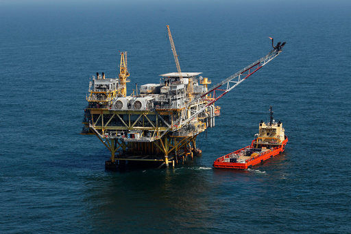 FILE - A rig and supply vessel are viewed in the Gulf of Mexico off the cost of Louisiana, April 10, 2011. AP Photo/Gerald Herbert, File)