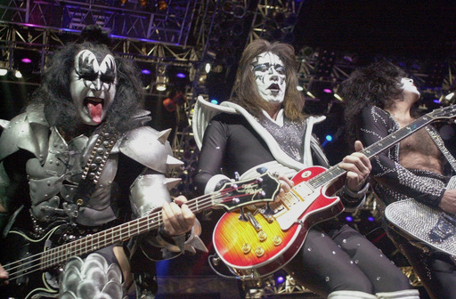 FILE - Kiss guitarist Paul Stanley, right, guitarist Ace Frehley, center, and bassist Gene Simmons play during the band's farewell concert in the Detroit area, Thursday, May 25, 2000, at the Palace of Auburn Hills, Mich.. (AP Photo/Paul Warner, File)