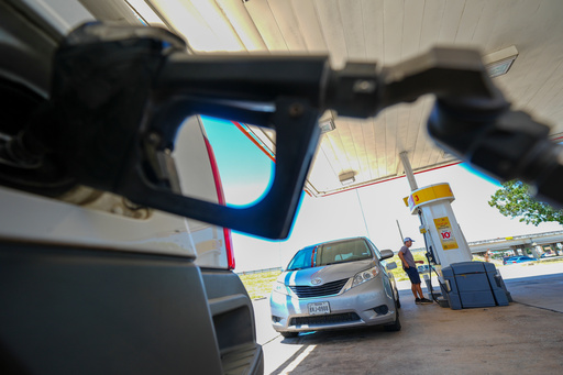 FILE - A person pays for fuel at a Shell gas station, Tuesday, July 29, 2025, in Arlington, Texas. (AP Photo/Julio Cortez, File)