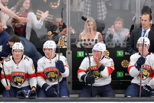 Florida Panthers left wing Brad Marchand (63), who played for more than 15 seasons with the Boston Bruins, reacts during a break in the first period of an NHL hockey game, Tuesday, Oct. 21, 2025, in Boston. (AP Photo/Charles Krupa)