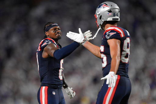 New England Patriots wide receiver Stefon Diggs, left, and New England Patriots tight end Hunter Henry, right, celebrate a play against the Buffalo Bills during the second half of an NFL football game, Sunday, Sept. 5, 2025, in Orchard Park, N.Y. (AP Photo/Adrian Kraus)