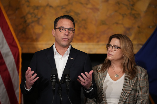 Pennsylvania Gov. Josh Shapiro, accompanied by his wife Lori Shapiro, speaks during a news conference after Cody Balmer plead guilty to attempted murder and other charges, on Tuesday, Oct. 14, 2025 in Harrisburg, Pa. (AP Photo/Matt Slocum)