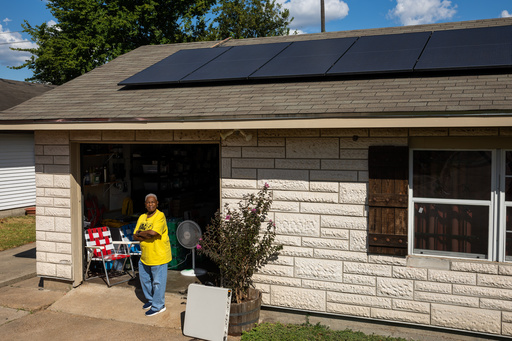 Doris Brown, Hub home captain, poses for a portrait under her solar panels on Wednesday, Oct. 8, 2025, in Houston. (AP Photo/Antranik Tavitian)