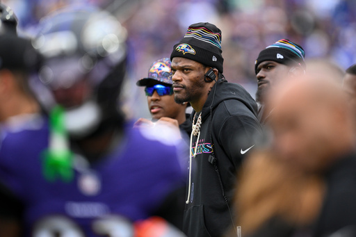 Baltimore Ravens quarterback Lamar Jackson looks on from the sidelines during the first half of an NFL football game against the Los Angeles Rams Sunday, Oct. 12, 2025, in Baltimore. (AP Photo/Nick Wass)