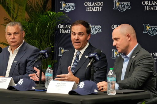 New Tampa Bay Rays ownership managing partner and co-chair Patrick Zalupski, center, answers a question, as co-chair Bill Cosgrove, left, and chief executive officer Ken Babby, right, look on during an introductory baseball news conference, Tuesday, Oct. 7, 2025, in Tampa, Fla. (AP Photo/Chris O'Meara)