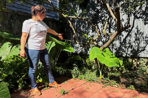 New Orleans resident Daniella Santoro points out the spot in her backyard where her family discovered a 1,900-year-old gravestone for a Roman sailor that had been missing for decades from an Italian museum, on Thursday, Oct. 9, 2025. (AP Photo/Jack Brook)