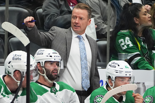 Dallas Stars head coach Glen Gulutzan directs his players in the second period of an NHL hockey game against the Colorado Avalanche, Saturday, Oct. 11, 2025, in Denver. (AP Photo/David Zalubowski)