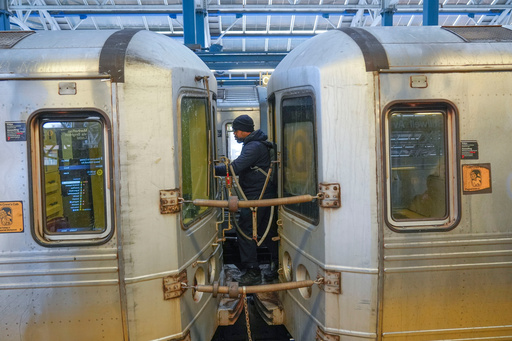 FILE - A train conductor walks between subway cars at a station in the Coney Island section of New York, Thursday, Jan. 23, 2025. (AP Photo/Seth Wenig, File)