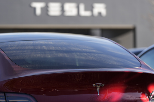 FILE - A Tesla model Y and other Telsla vehicles sit at a dealership, Wednesday, March 19, 2025, in Kennesaw, Ga. (AP Photo/Mike Stewart, File)