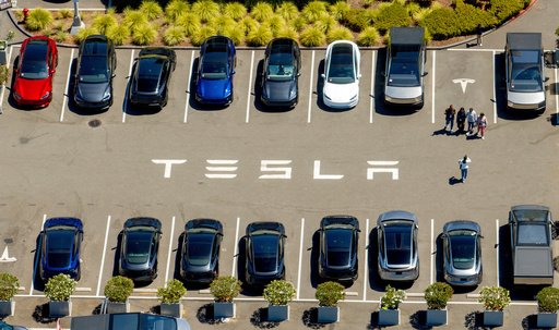FILE - Tesla vehicles line a parking area at the company's Fremont, Calif., factory on Tuesday, Aug. 5, 2025. (AP Photo/Noah Berger, File)