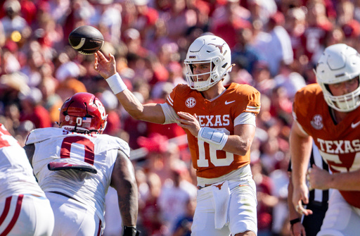 Texas quarterback Arch Manning, center, throws a pass during the first half of an NCAA college football game against Oklahoma, Saturday, Oct. 11, 2025, in Dallas. (AP Photo/Jeffrey McWhorter)