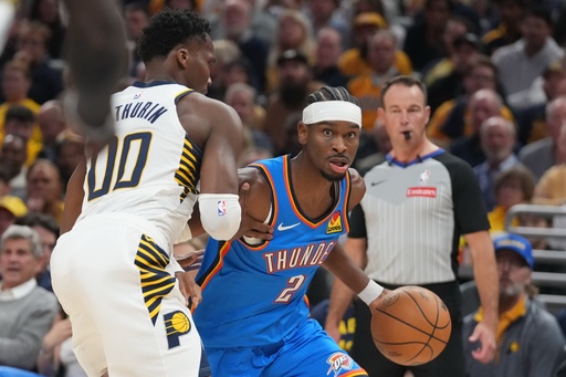 Oklahoma City Thunder's Shai Gilgeous-Alexander (2) is defended by Indiana Pacers' Bennedict Mathurin (00) during the first half of an NBA basketball game, Thursday, Oct. 23, 2025, in Indianapolis. (AP Photo/Darron Cummings)