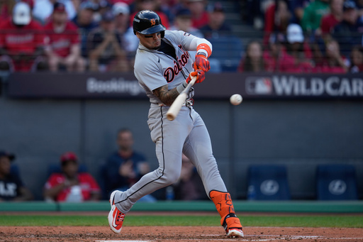 Detroit Tigers' Javier Báez (28) hits a double during the seventh inning of Game 3 of the American League Wild Card baseball playoff series against the Cleveland Guardians in Cleveland, Thursday, Oct. 2, 2025. (AP Photo/Sue Ogrocki)