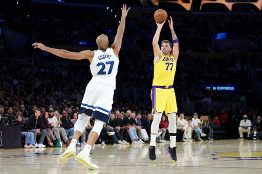 Los Angeles Lakers guard Luka Doncic (77) shoots against the Minnesota Timberwolves center Rudy Gobert (27) during the first half of an NBA basketball game, Friday, Oct. 24, 2025, in Los Angeles. (AP Photo/Jessie Alcheh)