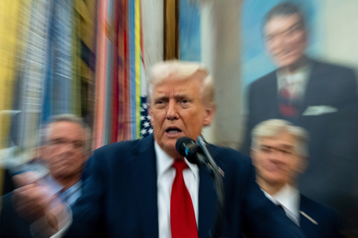 In this photo made with a slow shutter speed, President Donald Trump speaks in the Oval Office of the White House, Tuesday, Sept. 30, 2025, in Washington. (AP Photo/Alex Brandon)