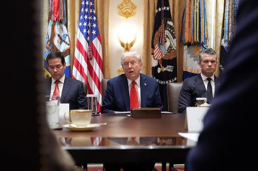 President Donald Trump speaks during a cabinet meeting at the White House, Thursday, Oct. 9, 2025, in Washington, as Secretary of State Marco Rubio, left, and Defense Secretary Pete Hegseth, right, look on. (AP Photo/Evan Vucci)