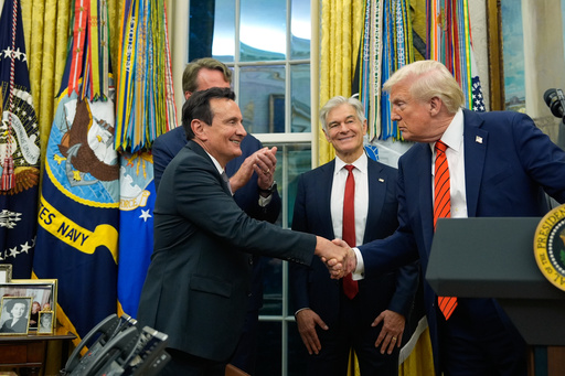 President Donald Trump shakes hands with AstraZeneca CEO Pascal Soriot in the Oval Office of the White House, Friday, Oct. 10, 2025, in Washington, as Virginia Gov. Glenn Youngkin and Centers for Medicare & Medicaid Services administrator Dr. Mehmet Oz watch. (AP Photo/Alex Brandon)