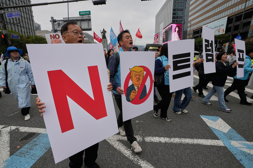 FILE - South Korean protesters march during a rally against U.S. President Donald Trump's tariffs policy on South Korea, in Seoul, South Korea, Oct. 18, 2025. The signs read "No Trump." (AP Photo/Ahn Young-joon, File)