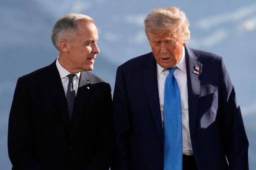 FILE - Canada's Prime Minister Mark Carney talks with President Donald Trump before a group photo at the G7 Summit, June 16, 2025, in Kananaskis, Canada. (AP Photo/Mark Schiefelbein, File)