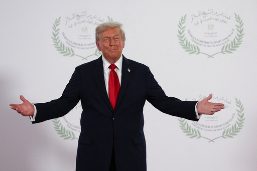 President Donald Trump waits to greet leaders during a summit to support ending the more than two-year Israel-Hamas war in Gaza after a breakthrough ceasefire deal, Monday, Oct. 13, 2025, in Sharm El Sheikh, Egypt. (Suzanne Plunkett/Pool via AP)