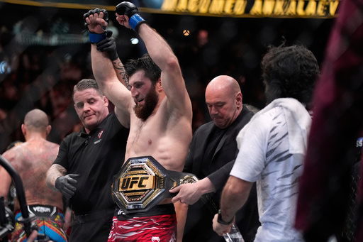 FILE - Dana White, CEO of the Ultimate Fighting Championship, puts the belt on Magomed Ankalaev after Ankalaev defeated Alex Pereira at a UFC 313 mixed martial arts light heavyweight title bout Saturday, March 8, 2025, in Las Vegas. (AP Photo/John Locher, File)