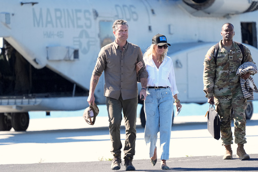 Defense Secretary Pete Hegseth, from left, and his wife Jennifer Rauchet walk during activities to mark the upcoming Marine Corps' 250th anniversary Saturday, Oct 18, 2025, on Marine Corps Base Camp Pendleton in Camp Pendleton, Calif. (AP Photo/Gregory Bull)