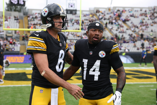 Pittsburgh Steelers quarterback Aaron Rodgers (8), left, and Pittsburgh Steelers running back Kenneth Gainwell (14) stand together before the start of the NFL football game between Minnesota Vikings and Pittsburgh Steelers at Croke Park stadium in Dublin, Sunday, Sept. 28, 2025.(AP Photo/Ian Walton)