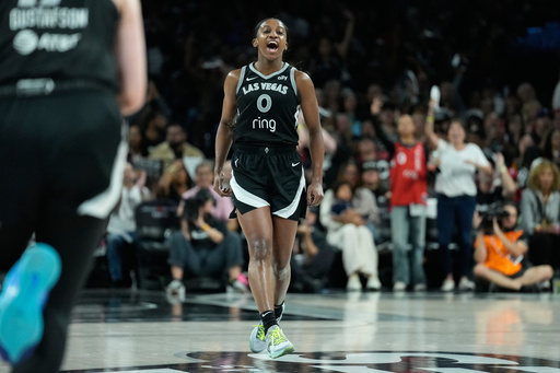Las Vegas Aces guard Jackie Young (0) celebrates after making a 3-point shot during the second half in Game 2 of the WNBA basketball finals against the Phoenix Mercury, Sunday, Oct. 5, 2025, in Las Vegas. (AP Photo/John Locher)