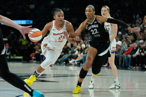 Phoenix Mercury forward Alyssa Thomas (25) drives was Las Vegas Aces center A'ja Wilson (22) defends during the first half in Game 1 of a WNBA basketball final playoff series Friday, Oct. 3, 2025, in Las Vegas. (AP Photo/John Locher)