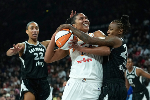 Las Vegas Aces guard Jewell Loyd (24), right, fouls Phoenix Mercury forward Alyssa Thomas (25) during the first half in Game 2 of the WNBA basketball finals, Sunday, Oct. 5, 2025, in Las Vegas. (AP Photo/John Locher)