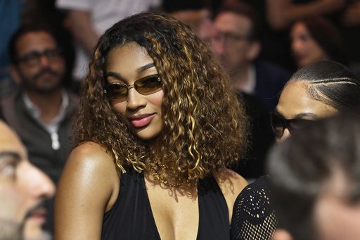 WNBA basketbal player Angel Reese sits at ringside during a super welterweight boxing match between Callum Walsh and Fernando Vargas Jr. in Las Vegas, Saturday, Sept. 13, 2025. (AP Photo/David Becker)