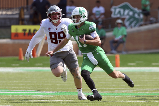 Washington State defensive tackle Bryson Lamb (99) pursues North Texas quarterback Drew Mestemaker (17), who runs with the ball, in the second quarter of an NCAA college football game, Saturday, Sept. 13, 2025, in Denton, Texas. (AP Photo/Richard W. Rodriguez)