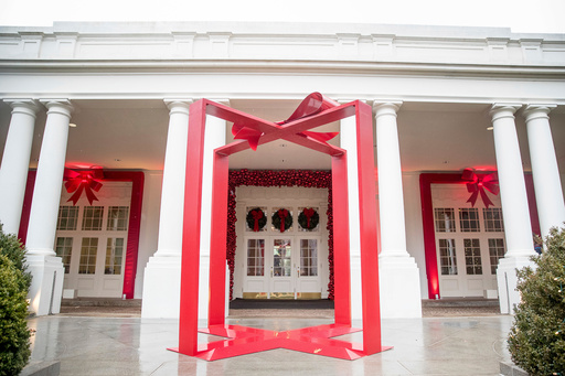 FILE - A large ribbon is displayed outside the East Wing of the White House during a preview of the 2016 holiday decor, Nov. 29, 2016, in Washington. (AP Photo/Andrew Harnik, File)