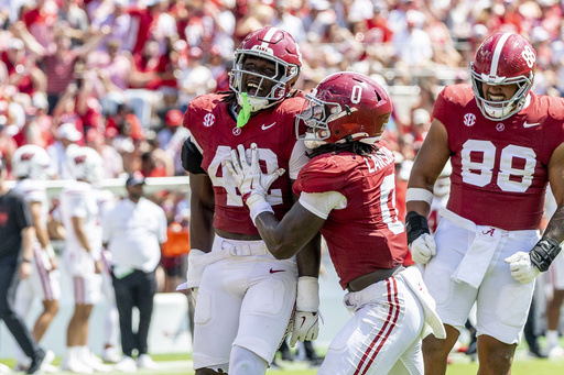 Alabama linebacker Yhonzae Pierre (42) celebrates a sack with Alabama linebacker Deontae Lawson (0) during the second half of an NCAA college football game against Wisconsin, Saturday, Sept. 13, 2025, in Tuscaloosa, Ala. (AP Photo/Vasha Hunt)