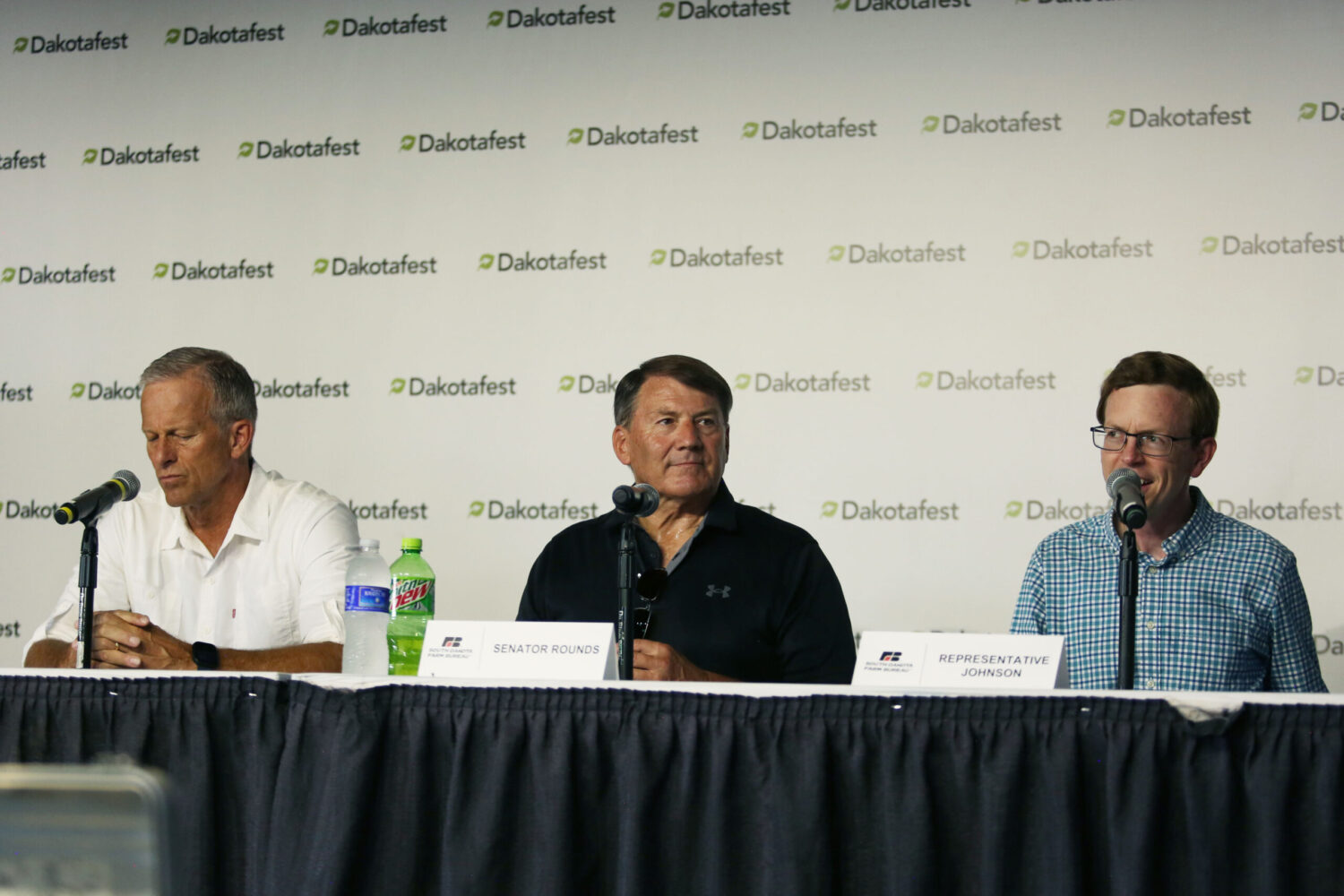 South Dakota Republican congressional delegates, from left, Senate Majority Leader John Thune, Sen. Mike Rounds and Rep. Dusty Johnson speak at Dakotafest in Mitchell, South Dakota, on Aug. 20, 2025. (Photo by Makenzie Huber/South Dakota Searchlight)