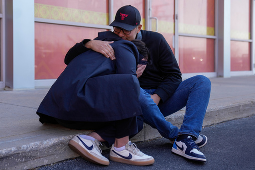 Maria Guzman, left, and Sergio Rocha, parents of young children, comfort each other outside of Rayito de Sol Spanish Immersion Early Learning Center after federal immigration agents took a daycare teacher Wednesday, Nov. 5, 2025, in Chicago. (AP Photo/Erin Hooley)