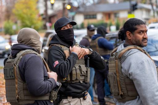 Federal law enforcement officers with Immigration and Customs Enforcement (ICE) and Enforcement and Removal Operations (ERO) conduct a traffic stop and detain people, Monday, Nov. 17, 2025, in Washington. (AP Photo/Alex Brandon)