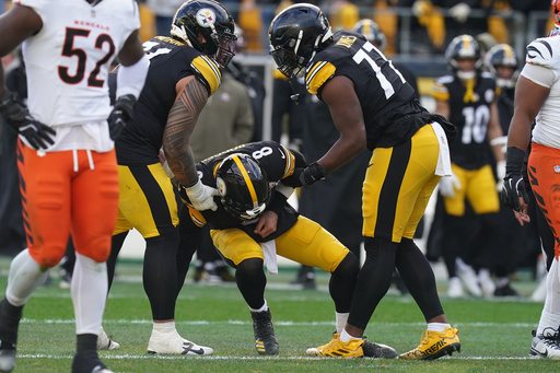 Pittsburgh Steelers quarterback Aaron Rodgers (8) is helped up off the field after a hit by the Cincinnati Bengals during the first half of an NFL football game Sunday, Nov. 16, 2025, in Pittsburgh. (AP Photo/Matt Freed)