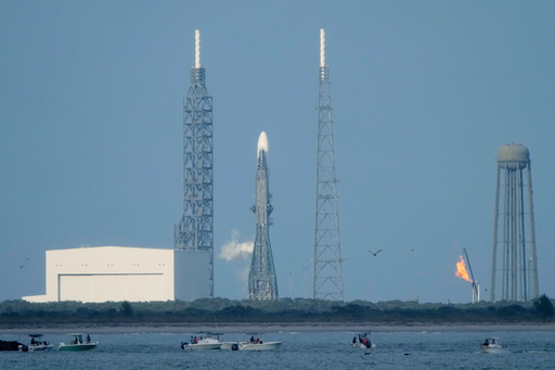 A Blue Origin New Glenn rocket stands ready on Launch Complex 36 a few minutes before the launch was scrubbed at the Cape Canaveral Space Force Station in Cape Canaveral, Fla., Sunday, Nov. 9, 2025. (AP Photo/John Raoux)