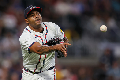 FILE- Atlanta Braves pitcher Raisel Iglesias throws to first base in the eighth inning of a baseball game against the Milwaukee Brewers, Aug. 6, 2025, in Atlanta. (AP Photo/Colin Hubbard, File)